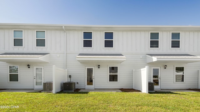 back of house featuring a patio area, central AC, and a lawn