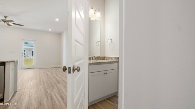 bathroom with vanity, wood-type flooring, and ceiling fan