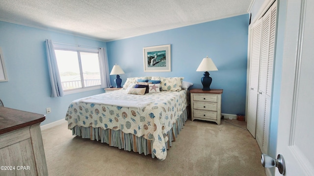 carpeted bedroom featuring a closet and a textured ceiling