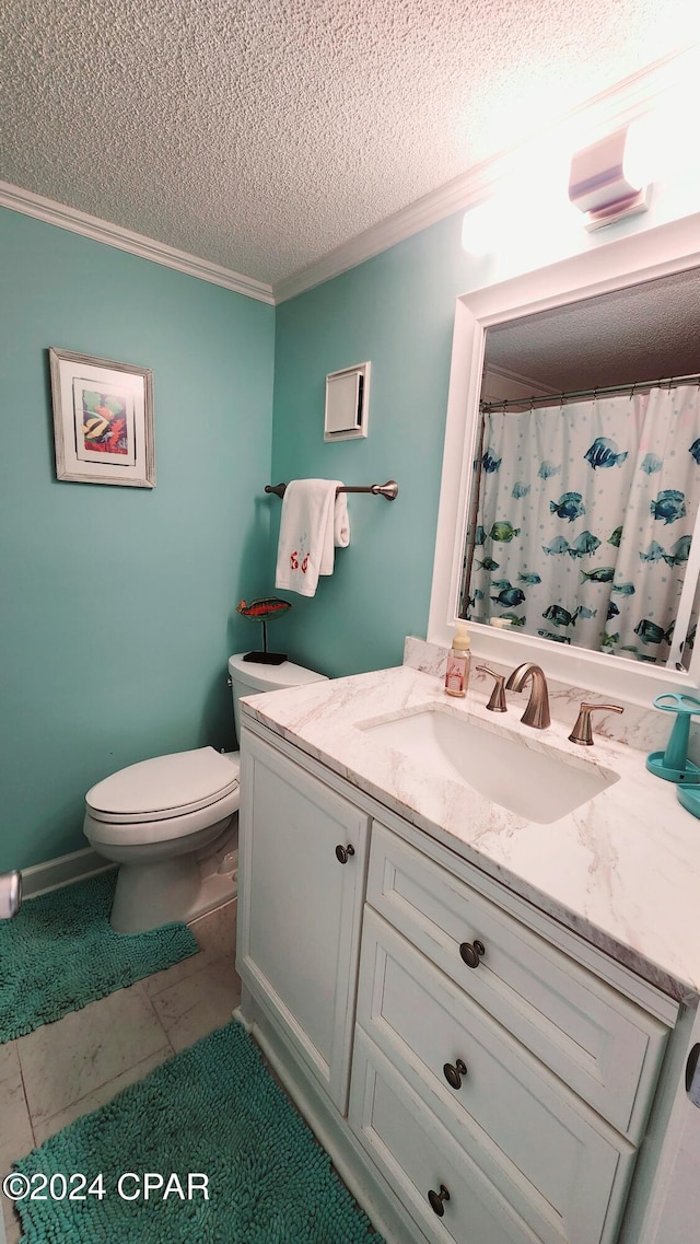 bathroom with tile patterned floors, toilet, ornamental molding, vanity, and a textured ceiling