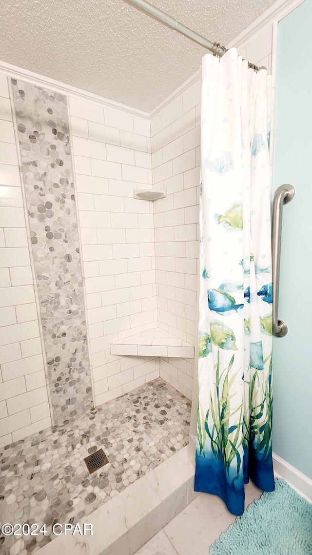 bathroom featuring a textured ceiling, curtained shower, and tile patterned floors