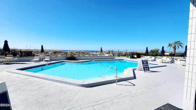 view of swimming pool with a patio area