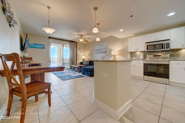 kitchen with white cabinetry, ceiling fan, pendant lighting, and appliances with stainless steel finishes