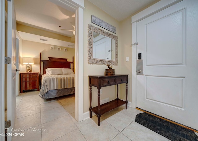 bedroom with ceiling fan and light tile patterned floors