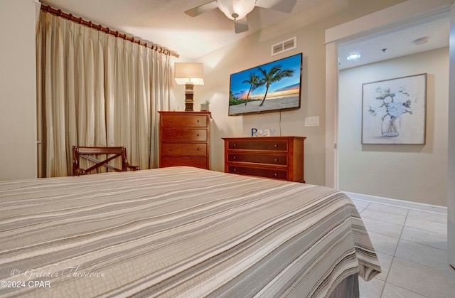 tiled bedroom featuring ceiling fan