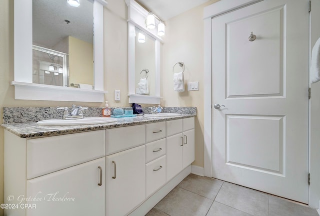 bathroom with tile patterned floors and vanity