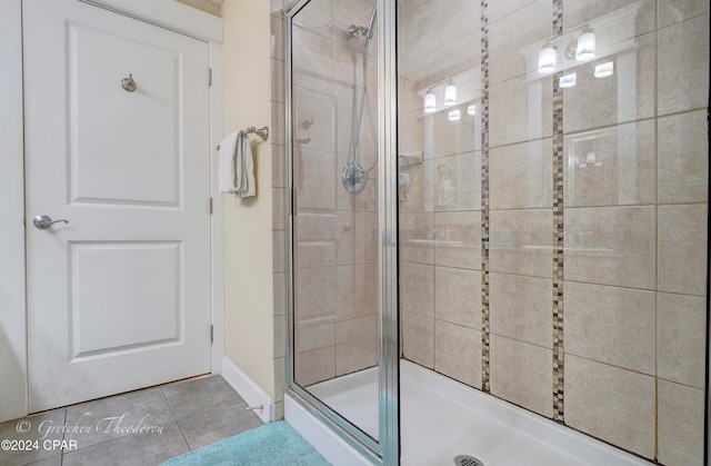 bathroom featuring tile patterned flooring and a shower with shower door