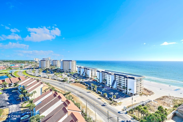 drone / aerial view with a water view and a beach view