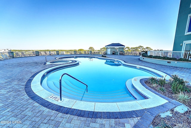 view of swimming pool with a patio area