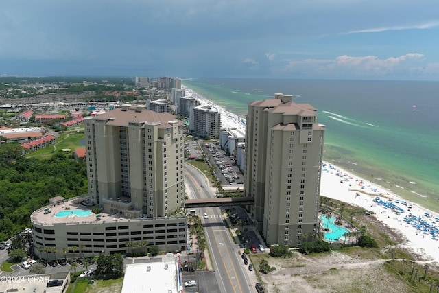 drone / aerial view featuring a beach view and a water view