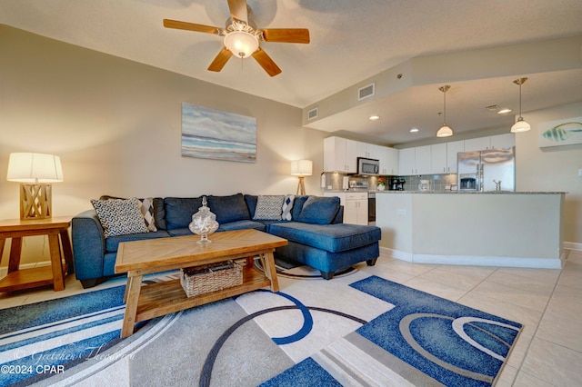 tiled living room with ceiling fan