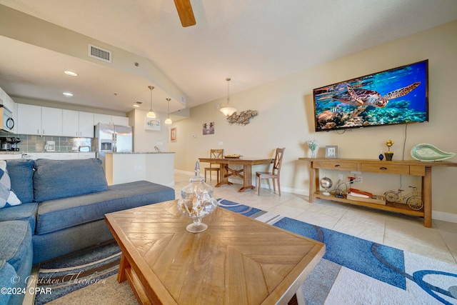 living room featuring light tile patterned floors and lofted ceiling