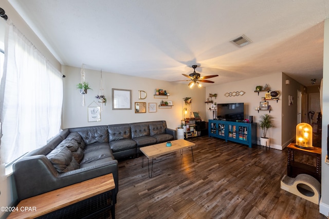 living room with ceiling fan and dark wood-type flooring