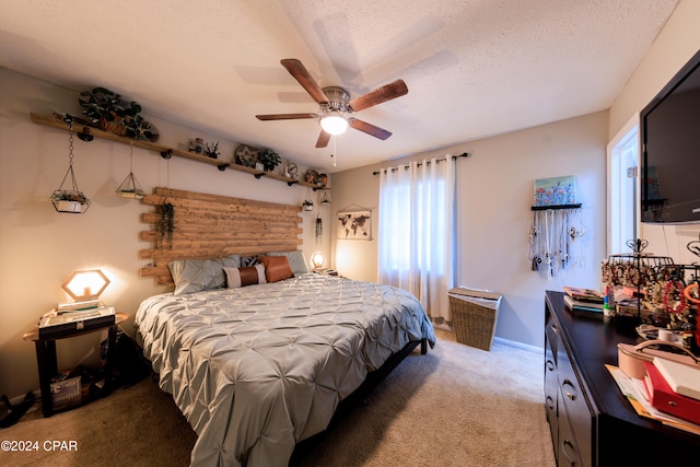 bedroom with carpet flooring, ceiling fan, and a textured ceiling