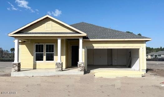 craftsman-style home with a garage and a front lawn