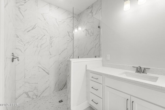 bathroom with vanity and tiled shower