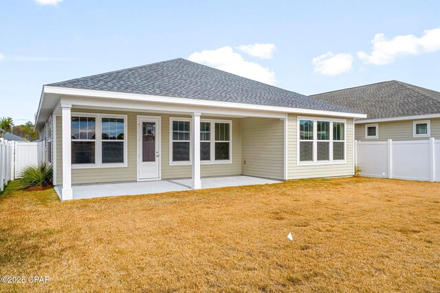 rear view of property featuring a yard and a patio