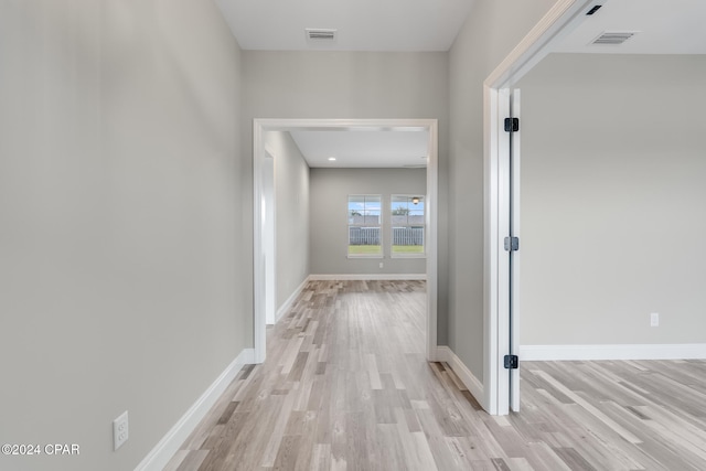 corridor with light hardwood / wood-style flooring