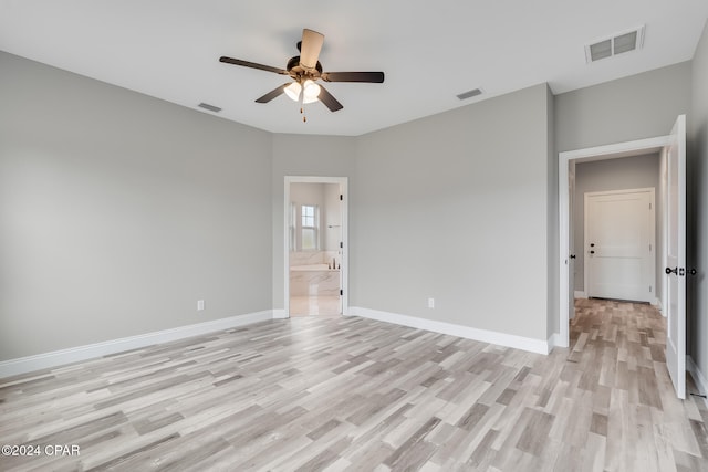 spare room featuring light wood-type flooring and ceiling fan