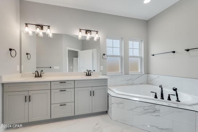 bathroom featuring vanity and a relaxing tiled tub