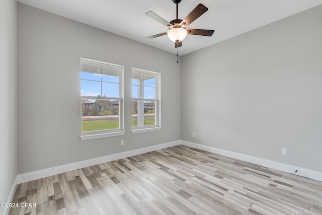 empty room with ceiling fan and light wood-type flooring