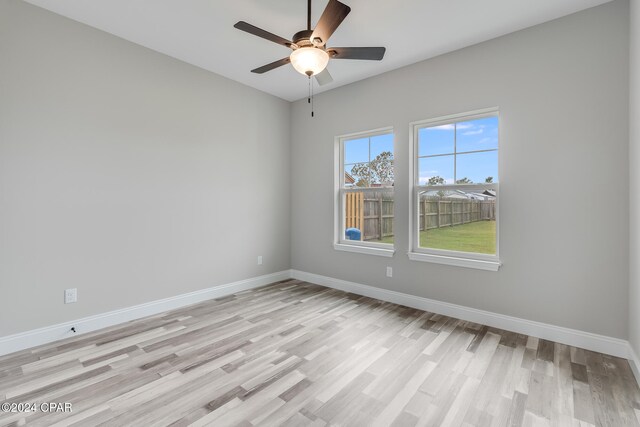 spare room featuring light wood-type flooring and ceiling fan