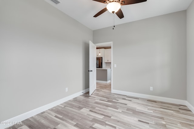 empty room featuring ceiling fan and light wood-type flooring