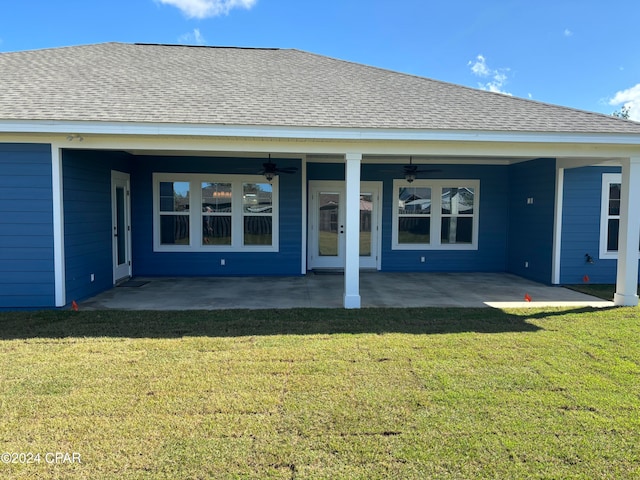 rear view of house with ceiling fan, a yard, and a patio