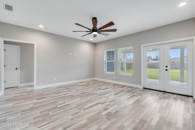 unfurnished room with ceiling fan, french doors, and light hardwood / wood-style flooring