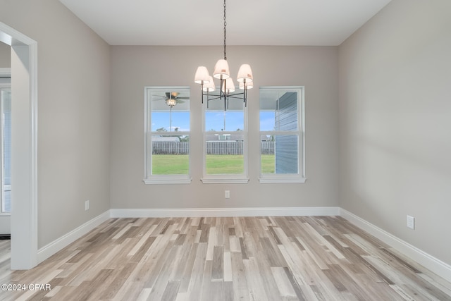 unfurnished dining area featuring light hardwood / wood-style flooring and a notable chandelier