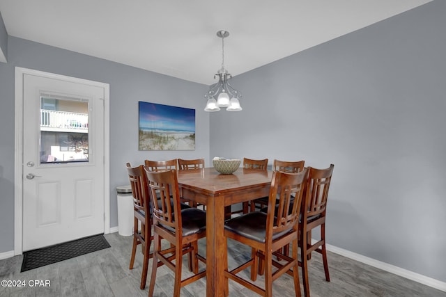 dining area featuring an inviting chandelier and wood-type flooring