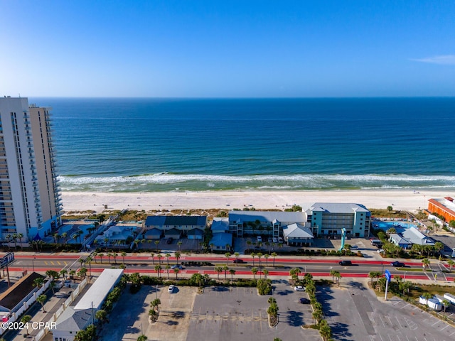 drone / aerial view featuring a beach view and a water view