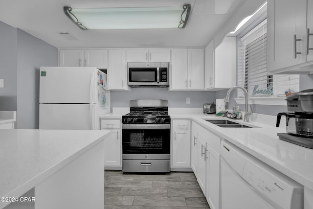 kitchen with white cabinetry, appliances with stainless steel finishes, and sink