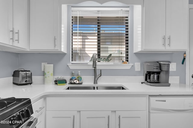 kitchen with white dishwasher, sink, white cabinetry, and black range with electric cooktop