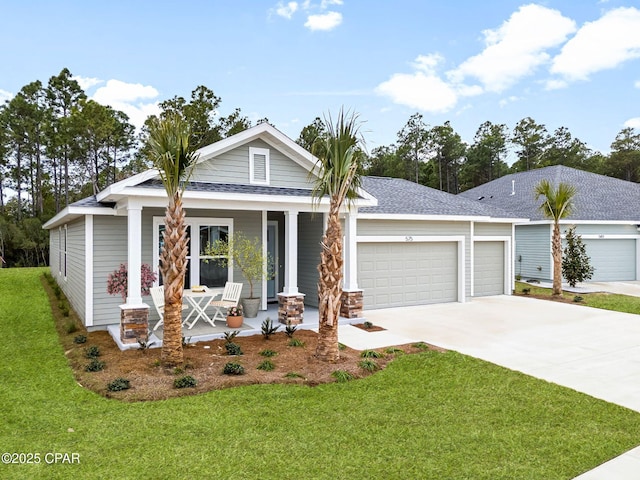 view of front of home featuring a garage, a porch, and a front lawn