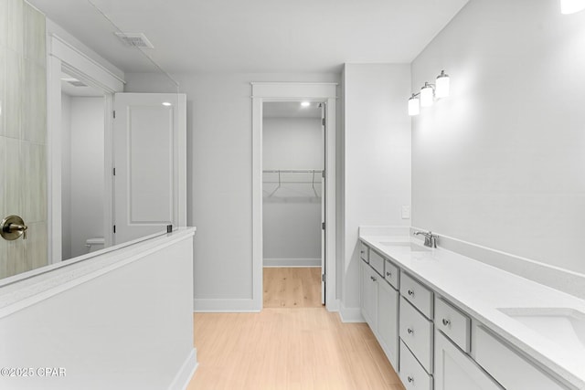 bathroom featuring vanity, hardwood / wood-style floors, and toilet