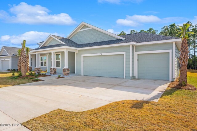 view of front of home with covered porch and a garage