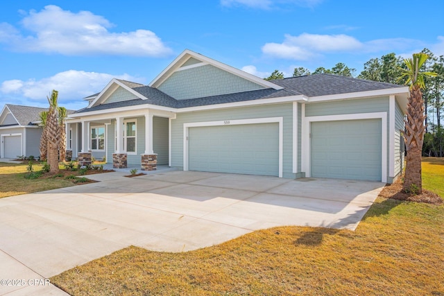 view of front of house with a garage, covered porch, and a front lawn