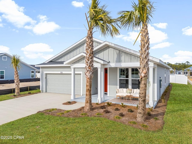 view of front of house with a garage, a front yard, and covered porch