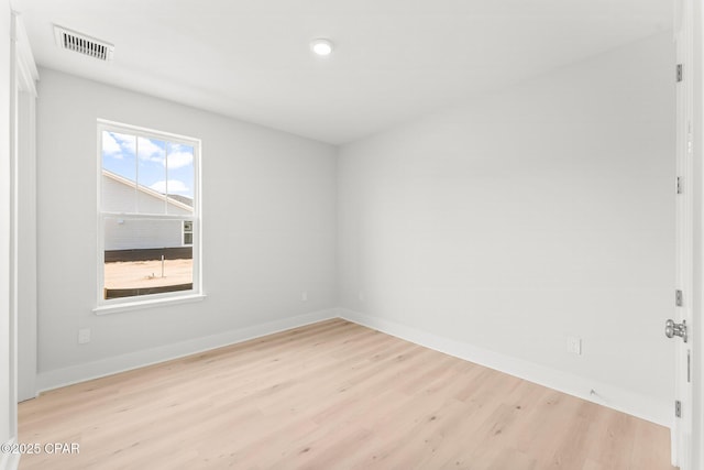 spare room featuring light wood-type flooring