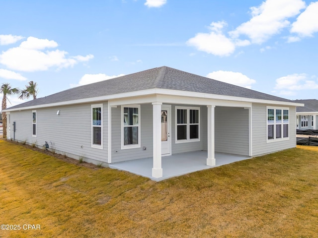 rear view of property with a patio area and a lawn