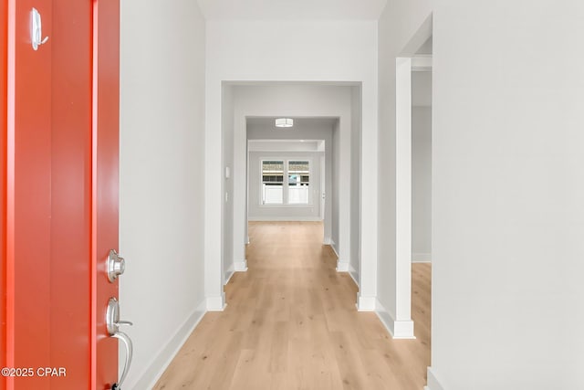 corridor with light hardwood / wood-style floors