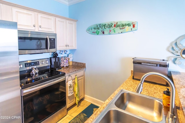 kitchen featuring sink, crown molding, light tile patterned floors, appliances with stainless steel finishes, and light stone counters