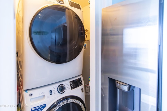 clothes washing area with stacked washer / dryer