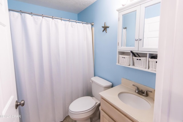 bathroom with vanity, a textured ceiling, and toilet