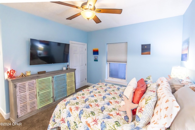 bedroom with ceiling fan and dark carpet