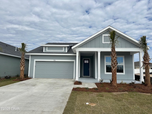 view of front of home with a front yard and a garage