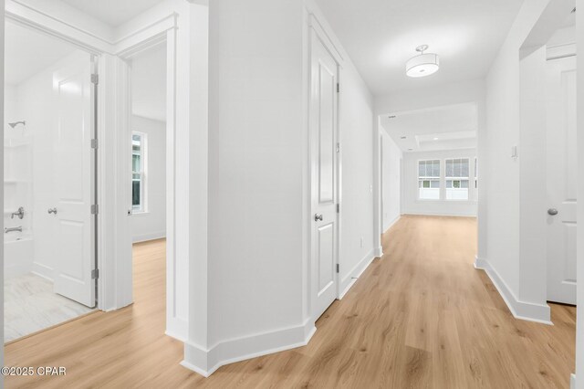 corridor with light hardwood / wood-style flooring