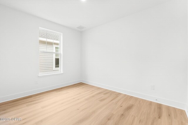 empty room with light hardwood / wood-style flooring