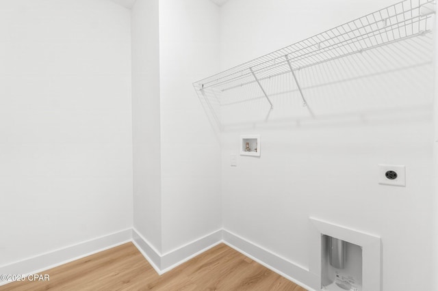 laundry area featuring electric dryer hookup, hookup for a washing machine, and wood-type flooring